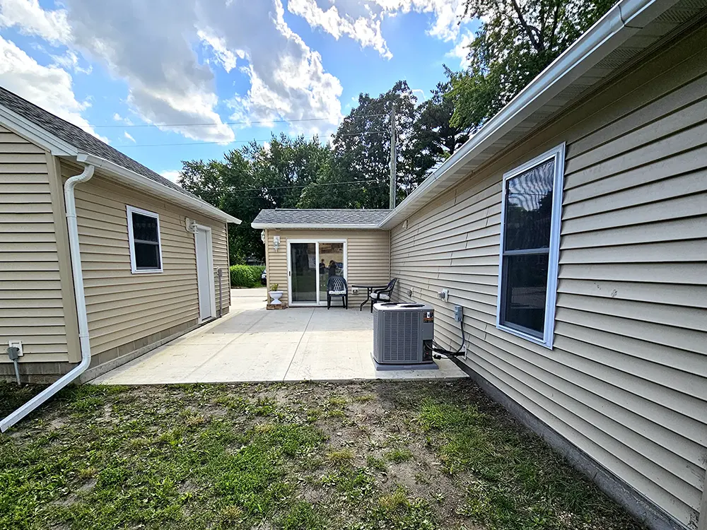 Private outdoor patio offers a cozy yet spacious retreat, easily accessed through the driveway/garage breezeway or the sliding glass doors off the back entry.