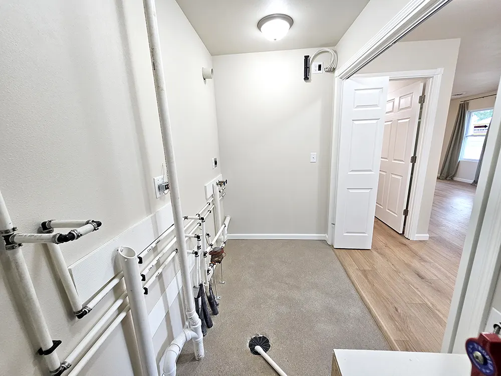 A centralized networking hub, discreetly tucked away in the utility room, features neatly routed whole-house wiring that supports fiber internet, phone, and cable service, along with a wired TV antenna delivering about 40 high-quality local channels.